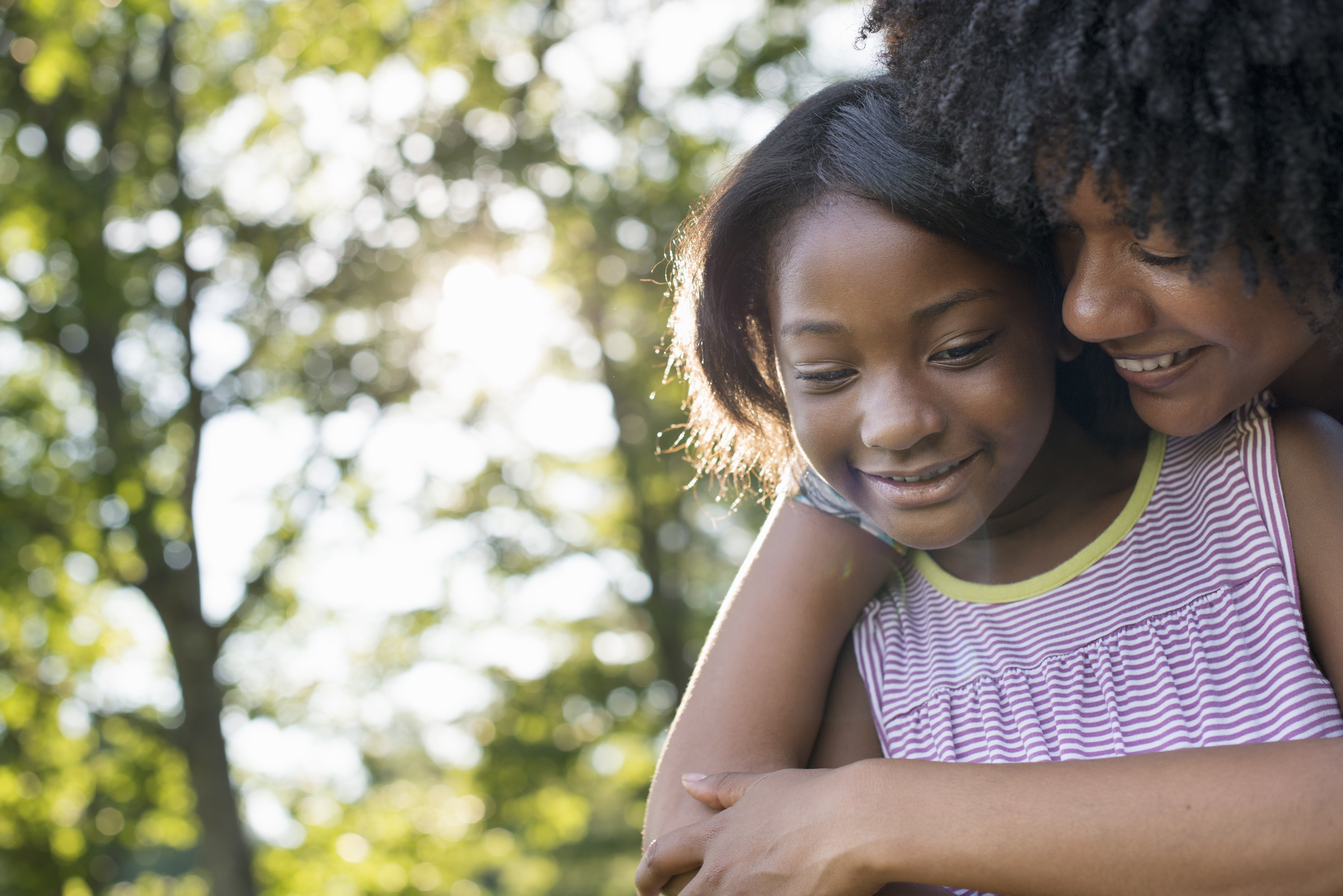 A woman hugging a young girl