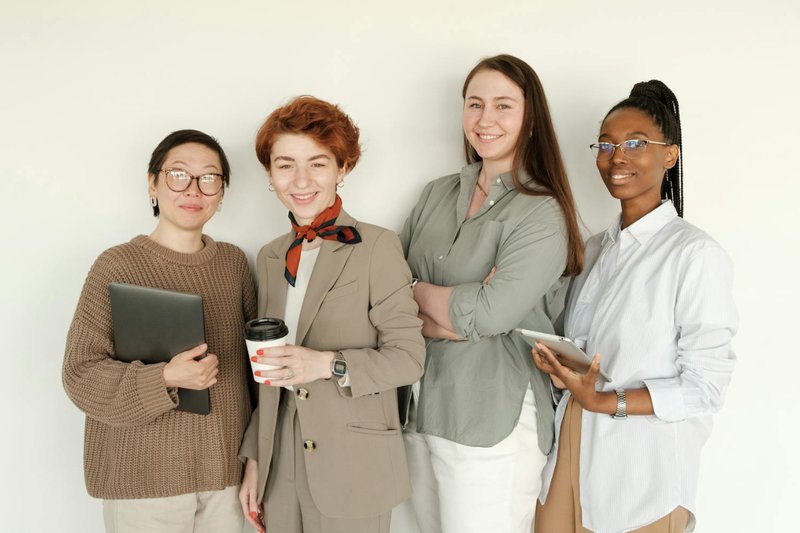 A group of four women smile at the camera